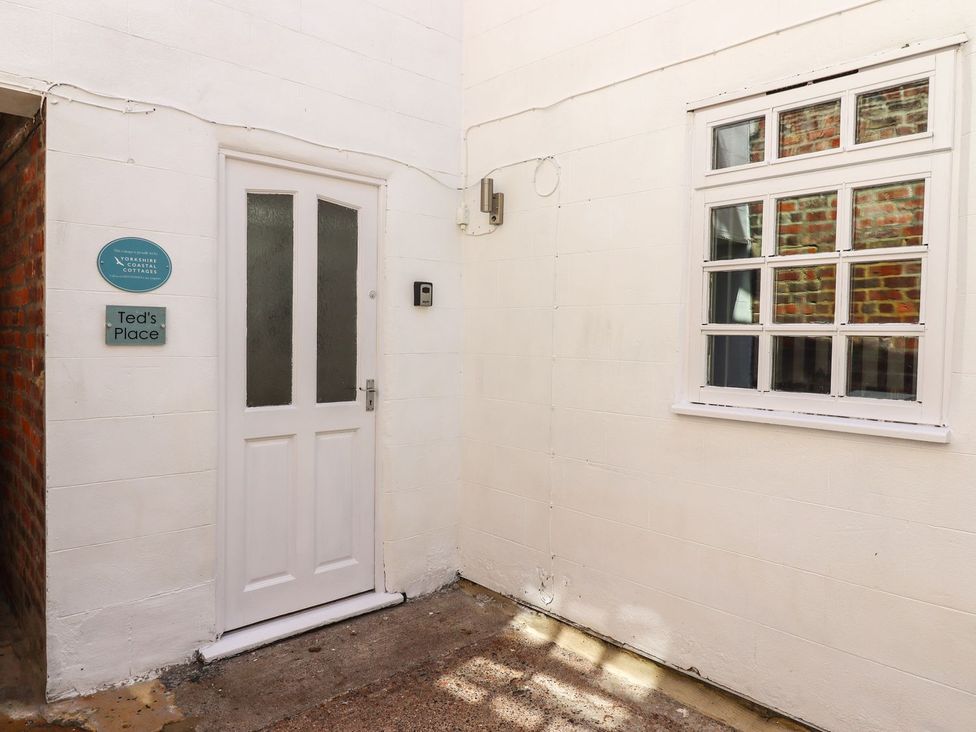 An outdoor area with a door and window at Ted's Place in Whitby