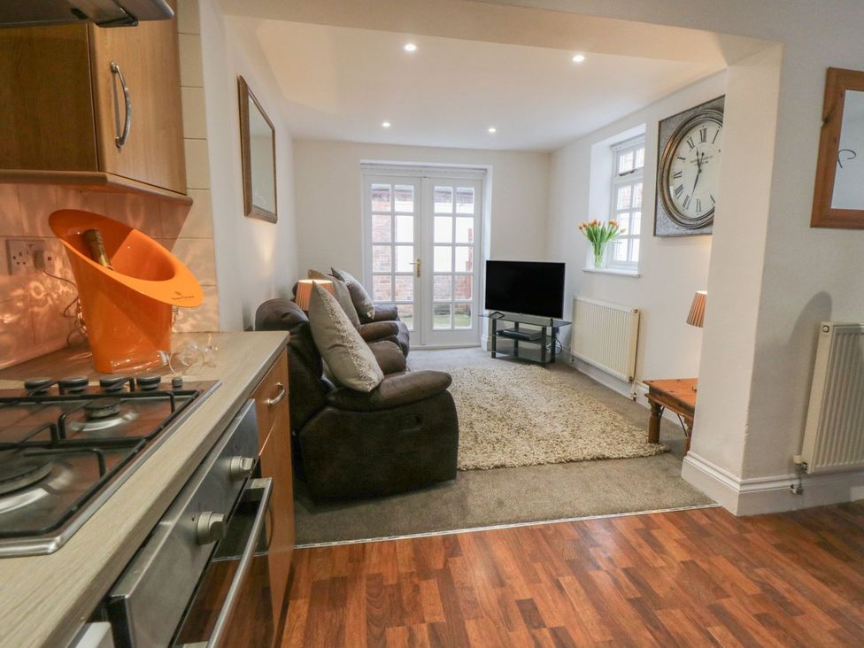 A living room with a sofa and television at Ted's Place in Whitby