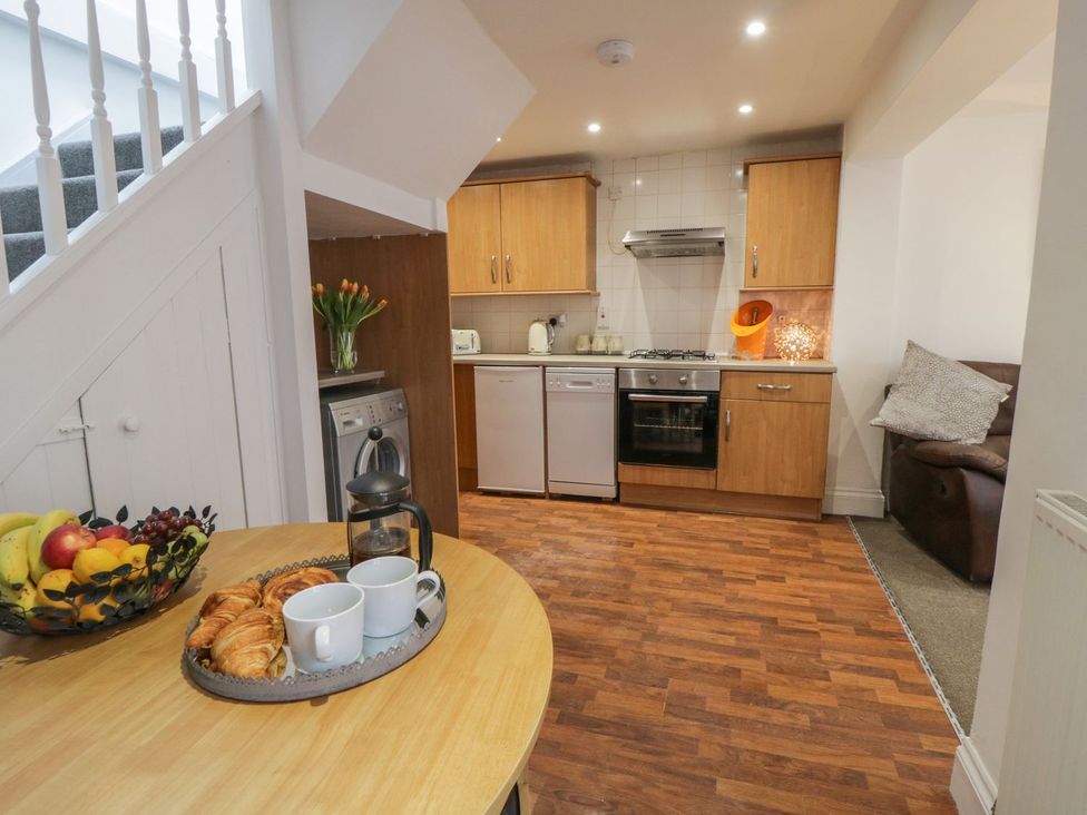 A kitchen with a dining table and a sofa at Ted's Place in Whitby