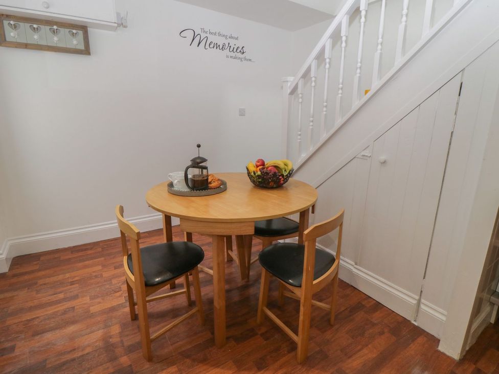 A dining room with a table and chairs at Ted's Place in Whitby
