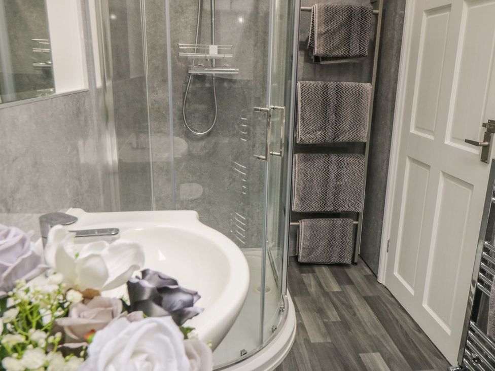 A bathroom with a shower and sink at Ted's Place in Whitby