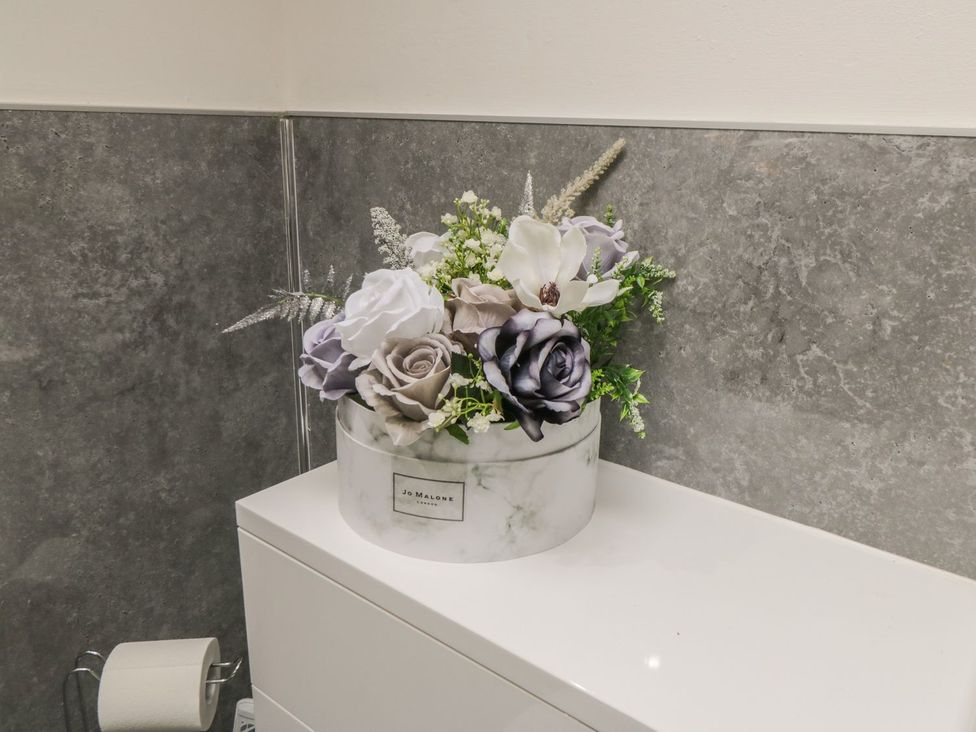 A flower arrangement on a bathroom counter at Ted's Place in Whitby