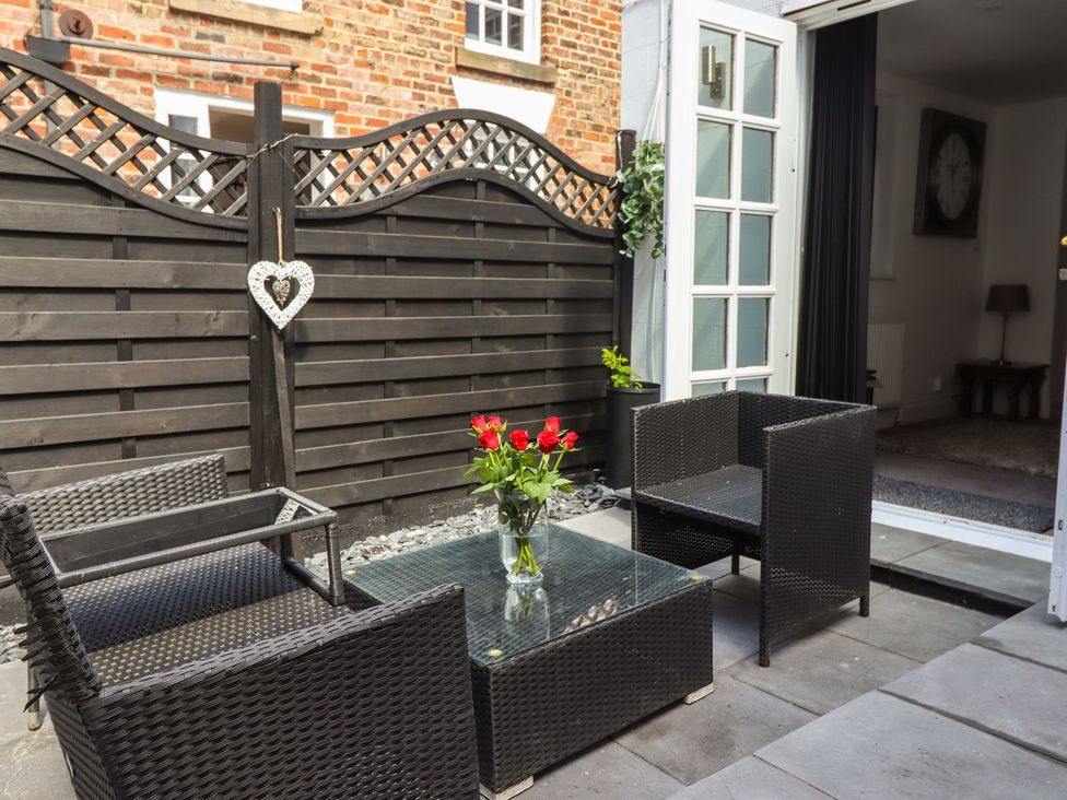 A patio with chairs and a table at Ted's Place in Whitby