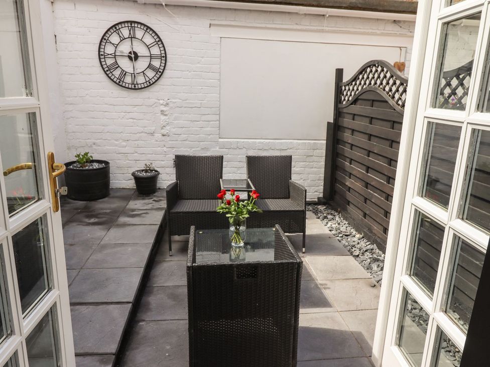 An outdoor patio with a table and chairs at Ted's Place in Whitby