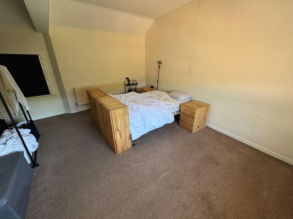 A bedroom with a bed and two nightstands at 31 High Street, Telford