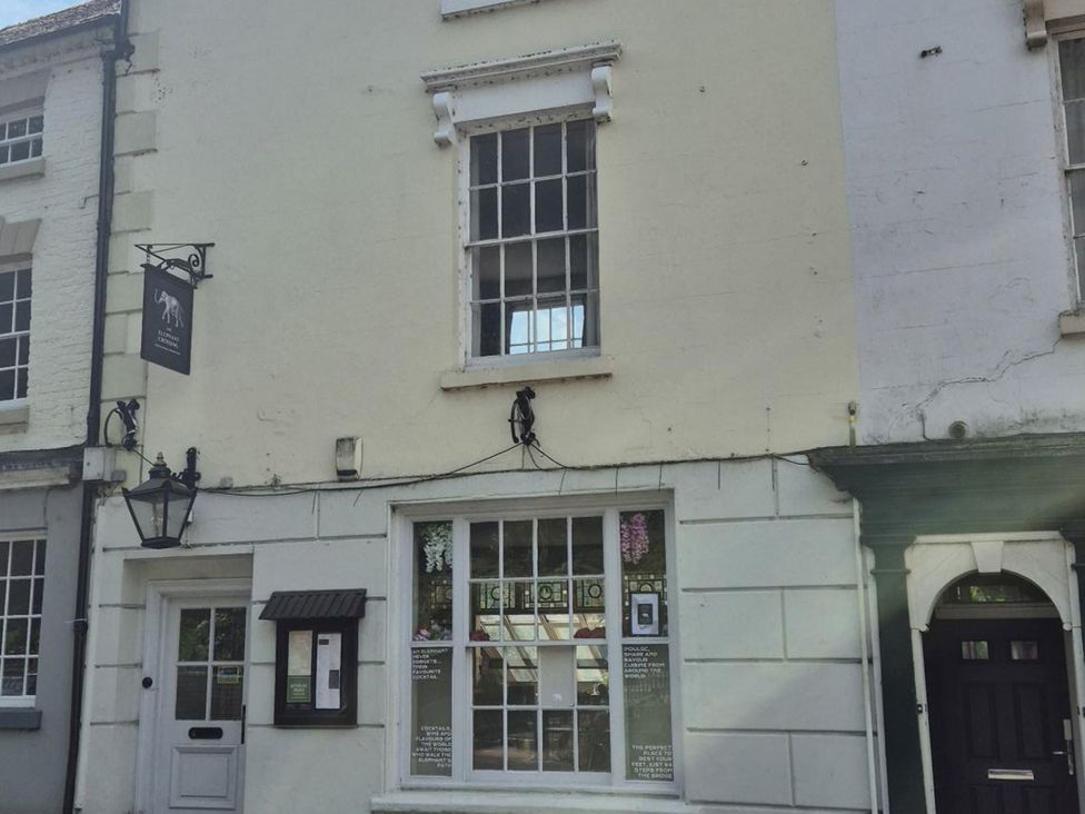 A building with a sign and menu board at 31 High Street in Telford