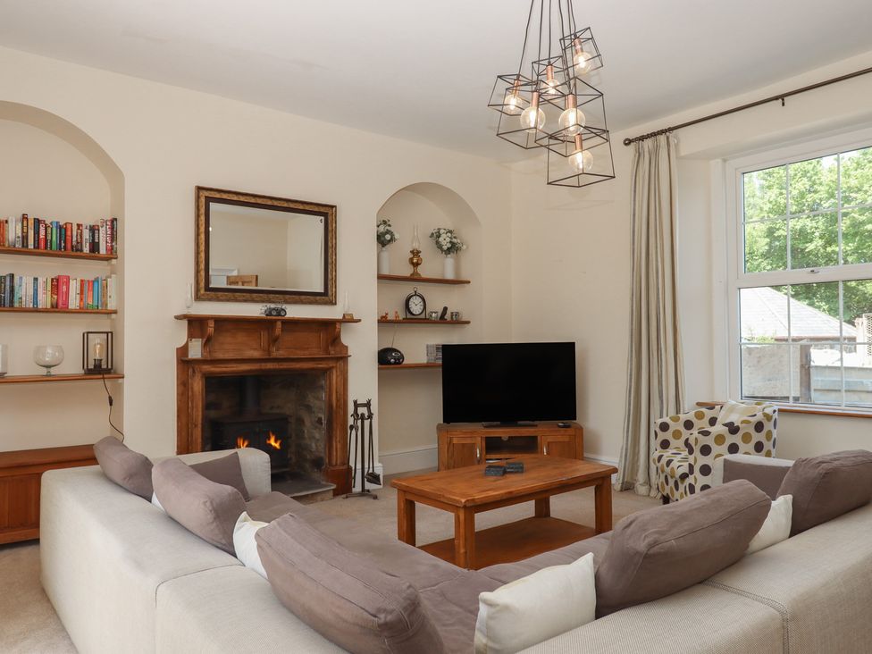 A living room with a fireplace and sofa at Littleham Court Manor in Littleham near Bideford