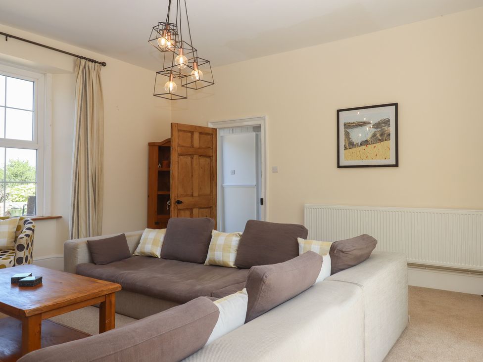 A living room with a sofa and coffee table at Littleham Court Manor Littleham near Bideford