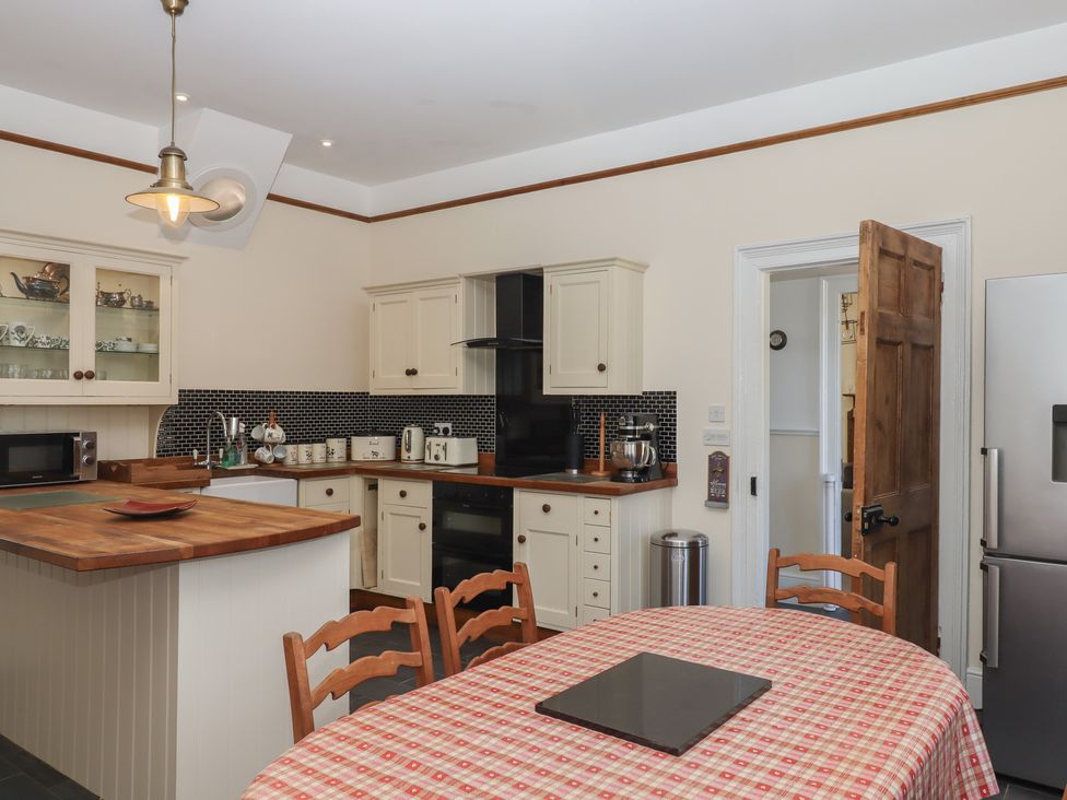 A kitchen with a table and chairs at Littleham Court Manor Littleham near Bideford