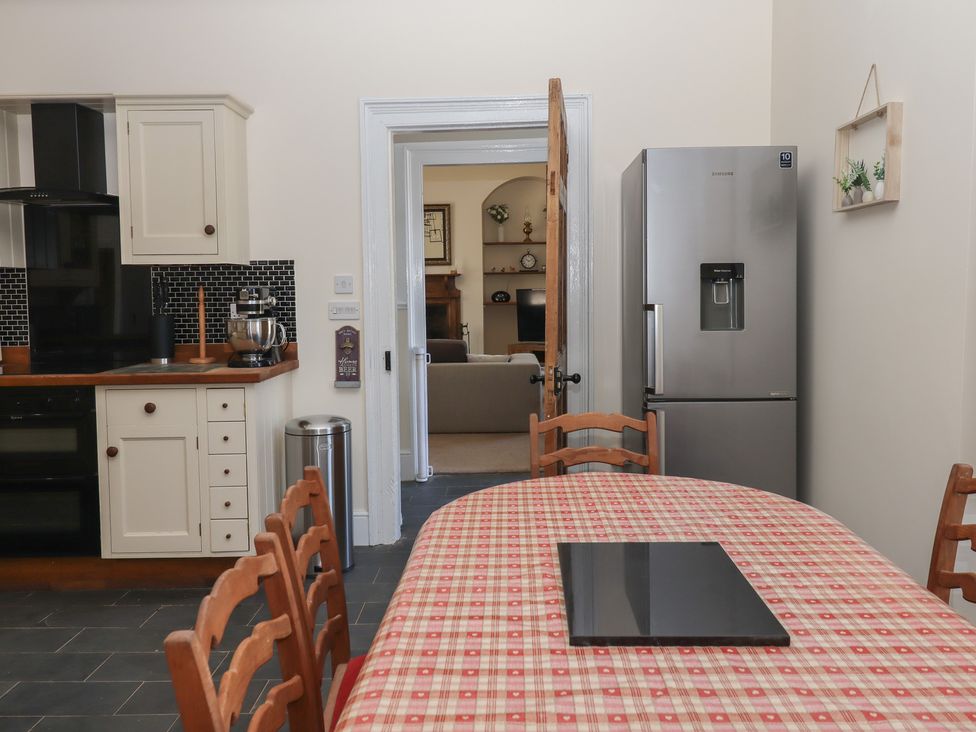 A kitchen with a table and chairs at Littleham Court Manor Littleham near Bideford