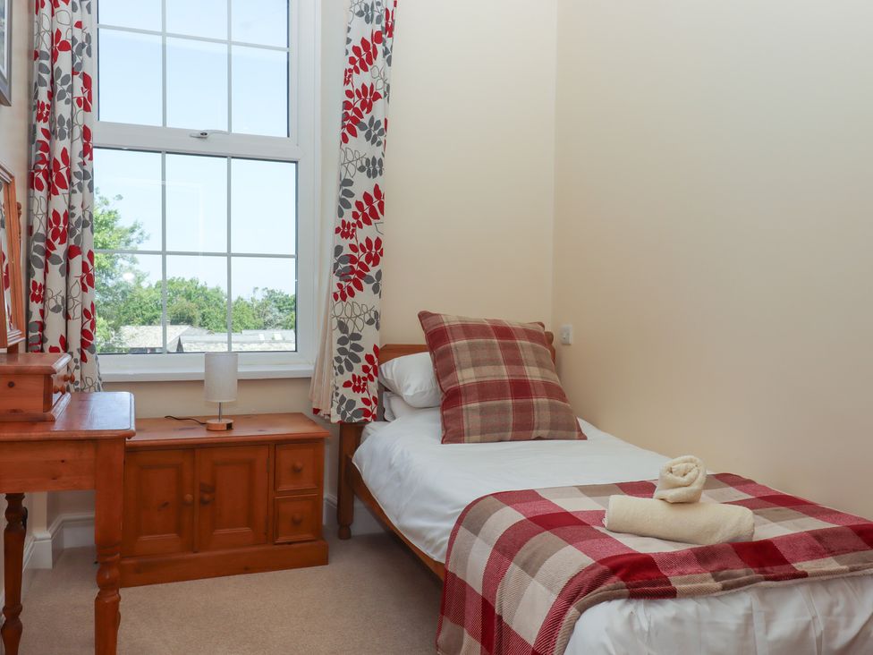 A bedroom with a single bed and a bedside table at Littleham Court Manor in Littleham near Bideford