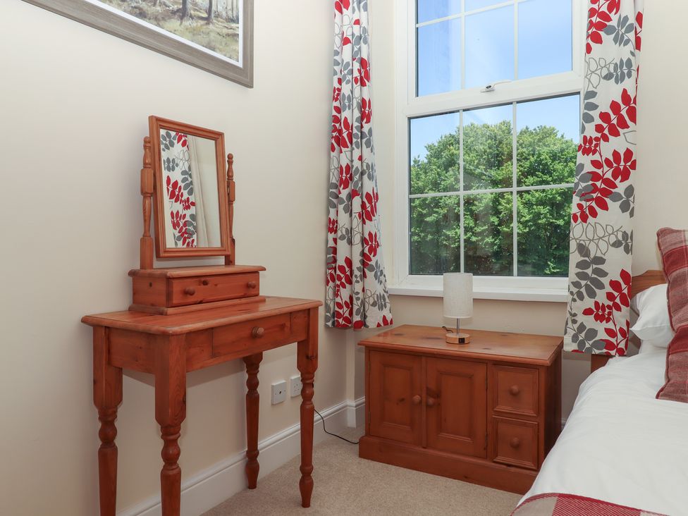A bedroom with a dressing table and lamp at Littleham Court Manor Littleham near Bideford