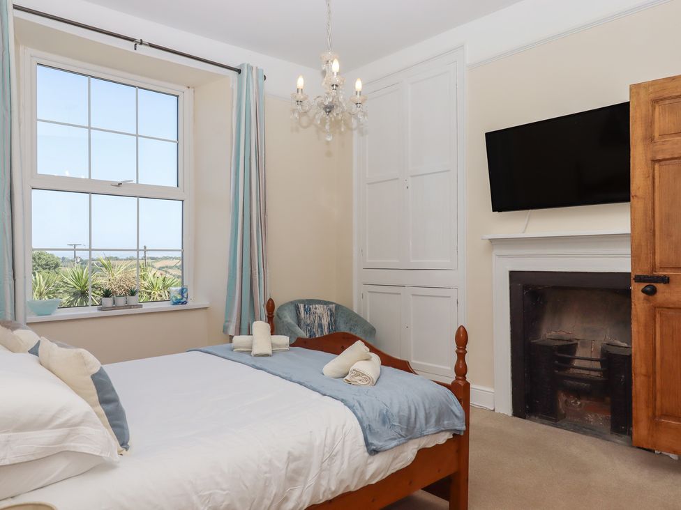 A bedroom with a window and bed at Littleham Court Manor Littleham near Bideford