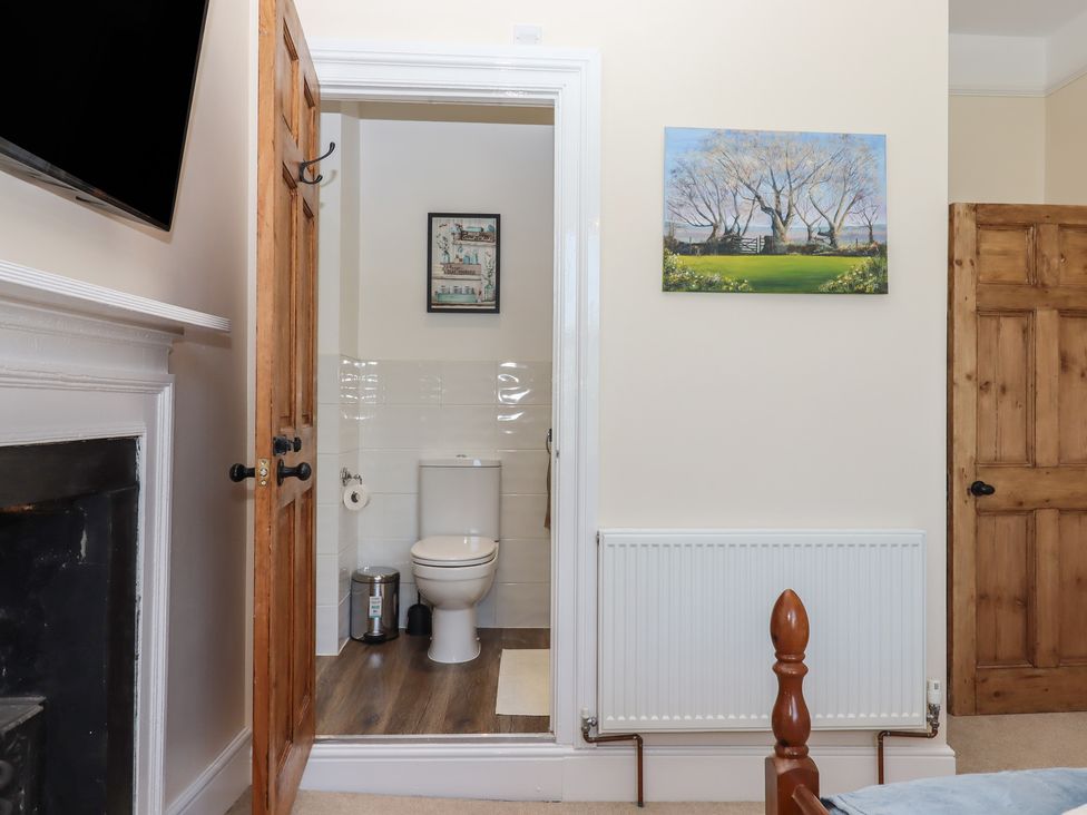 A bathroom with a toilet and radiator at Littleham Court Manor Littleham near Bideford