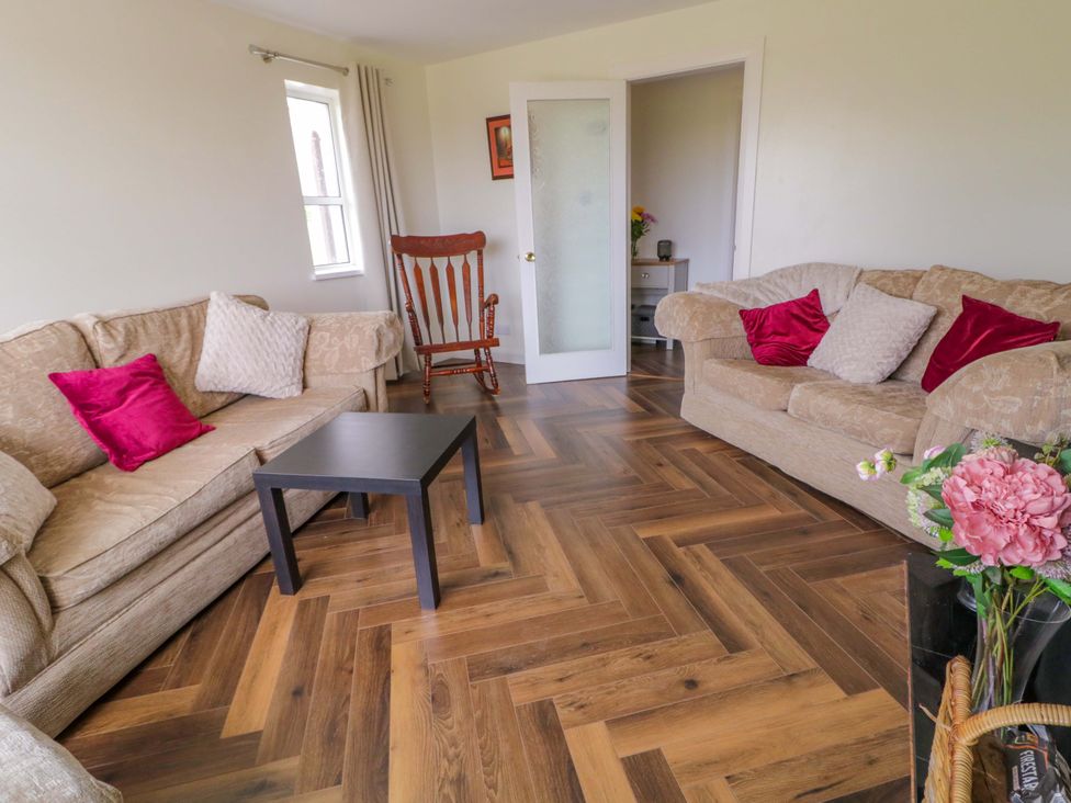 A living room with sofas and a table at Ard Na Mara 
