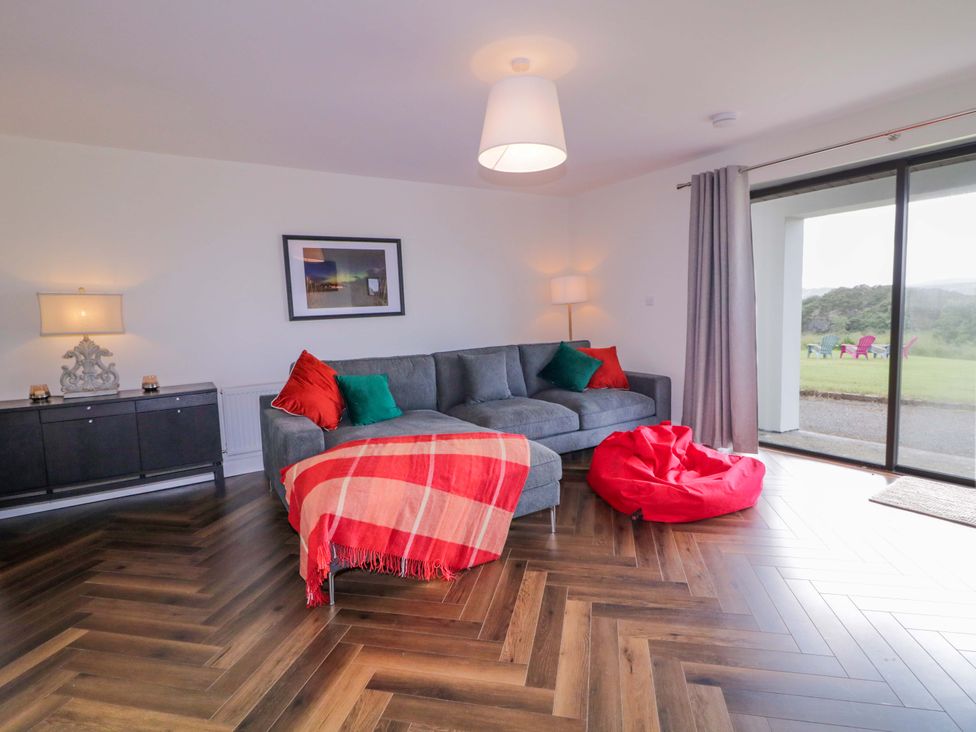 A living room with a sofa and bean bag at Ard Na Mara