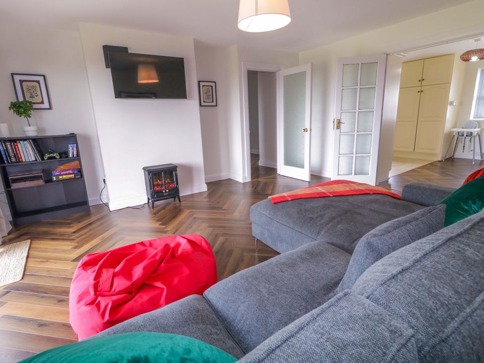A living room with a sofa and television at Ard Na Mara