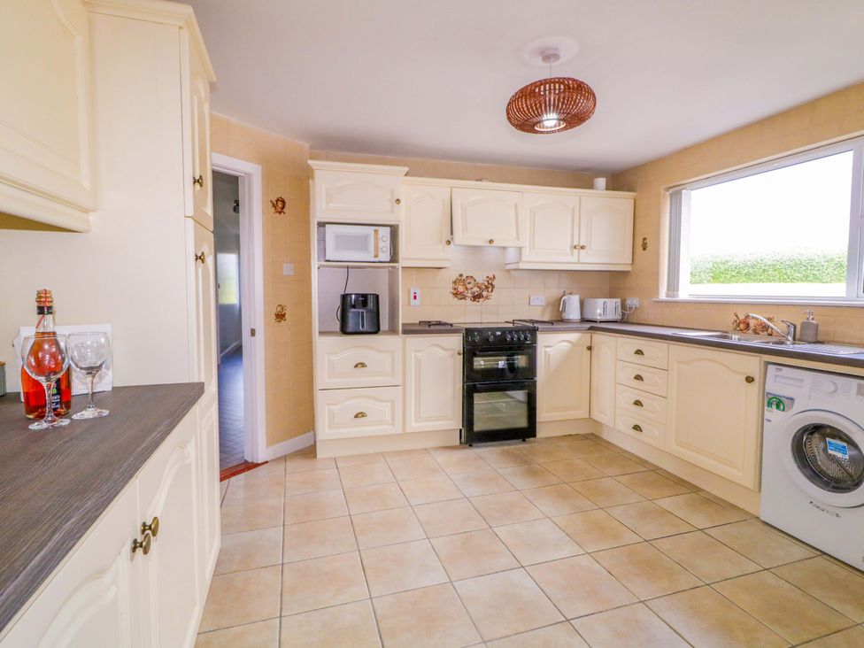 A kitchen with appliances and a window at Ard Na Mara