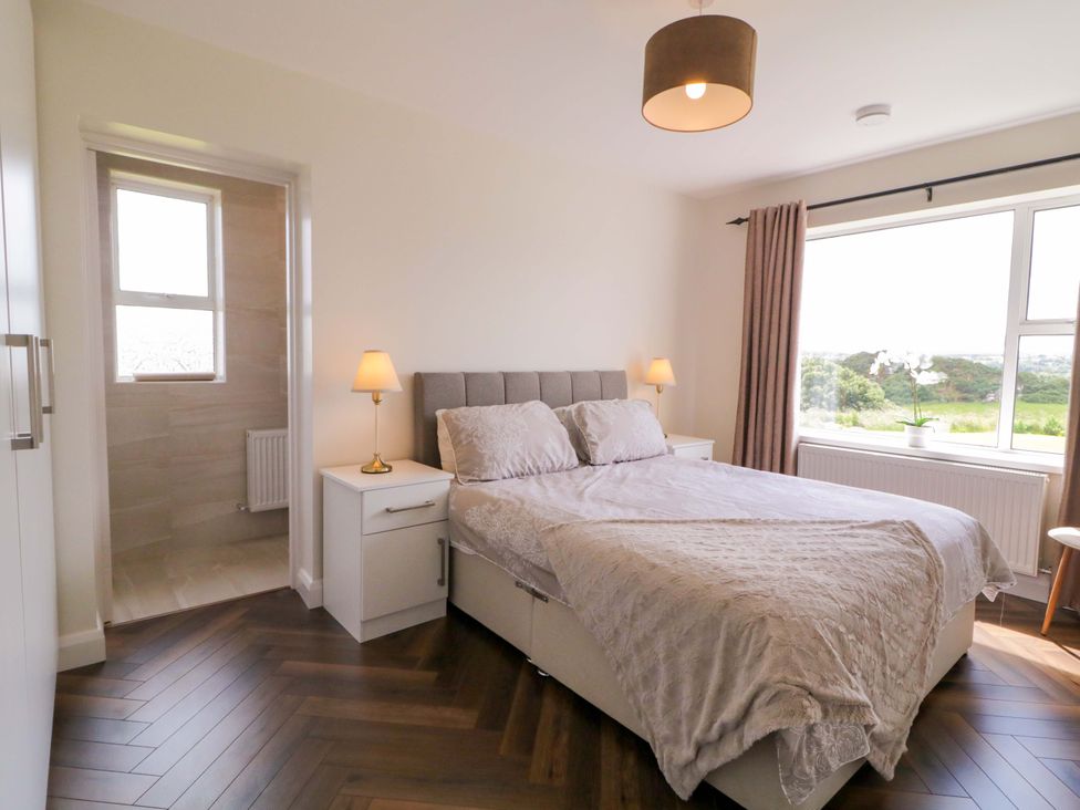 A bedroom with a bed and window at Ard Na Mara