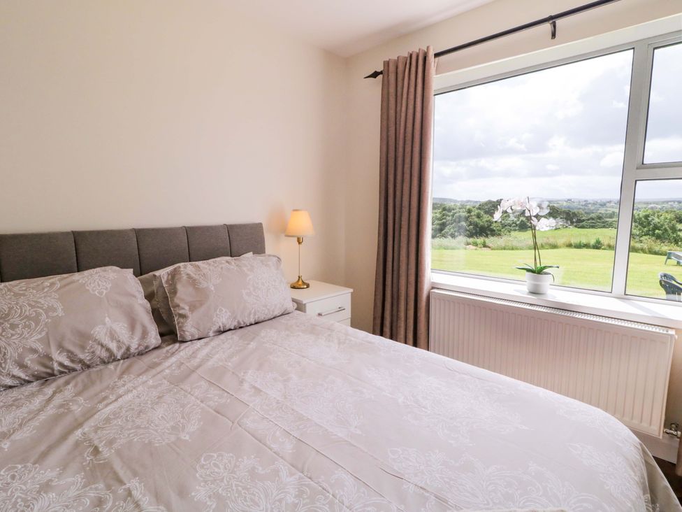 A bedroom with a bed and a view at Ard Na Mara in 
