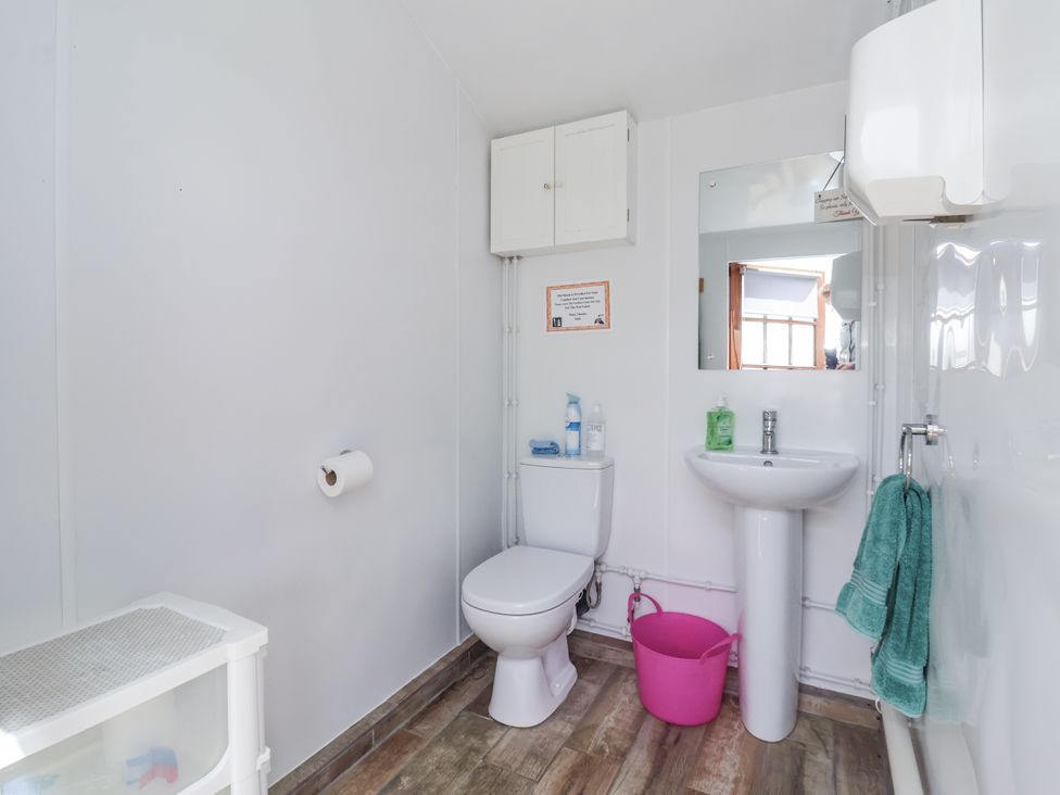 A bathroom with a toilet and sink at Shepherd's Hut in Market Weighton