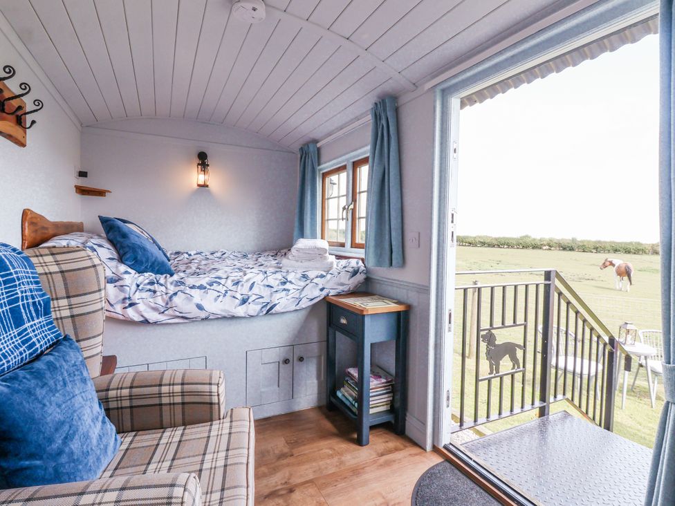 A room with a bed and chair at Wolds Hoot in Market Weighton