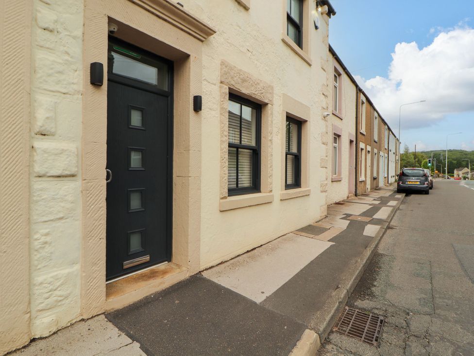 A facade of a house with a door and windows at Flat 1 in Carnforth