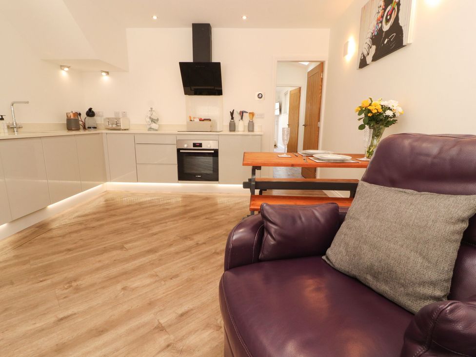 A kitchen with table and chairs at Flat 1 in Carnforth