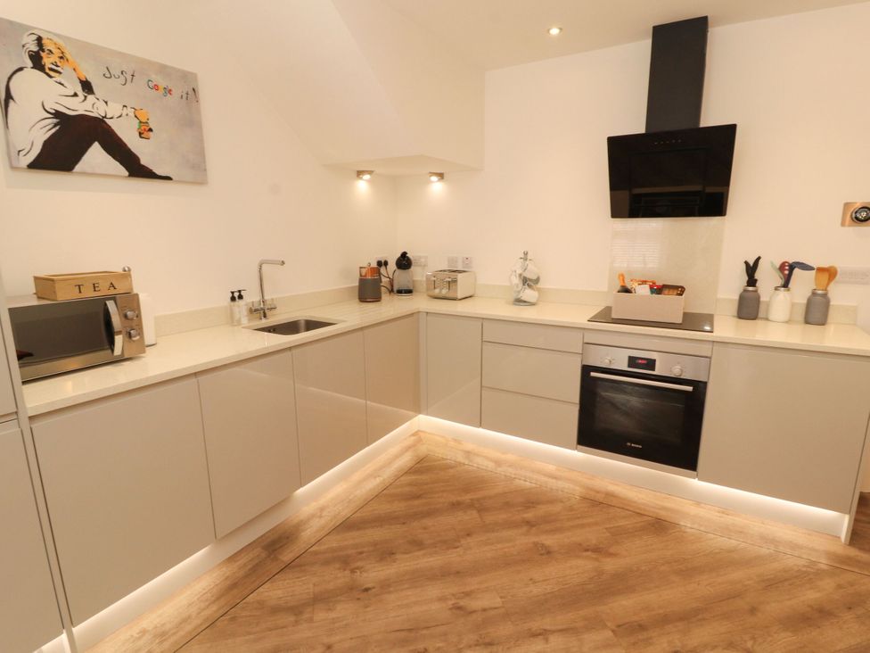A kitchen with cabinets and appliances at Flat 1 in Carnforth