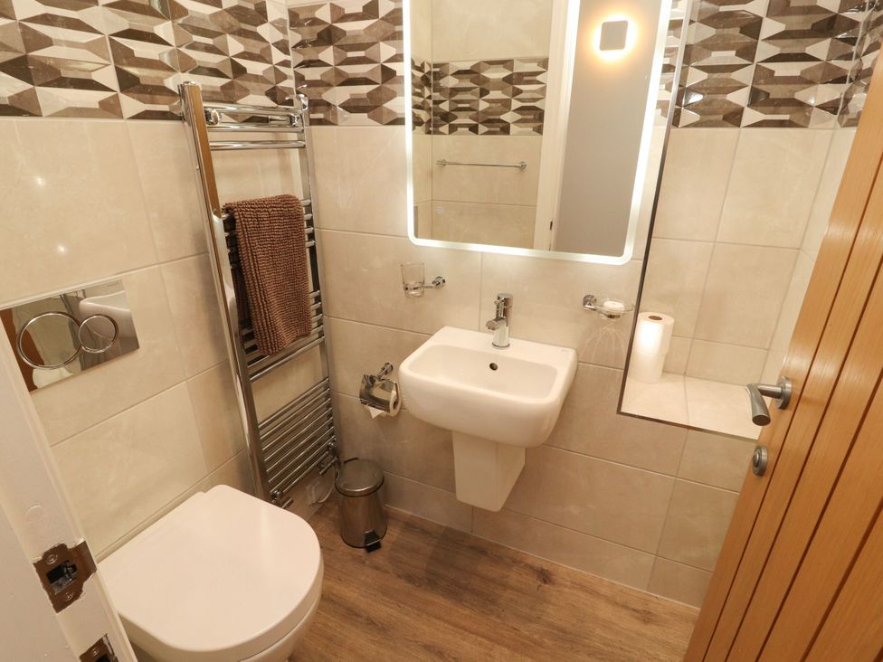 A bathroom with toilet and sink at Flat 1 in Carnforth