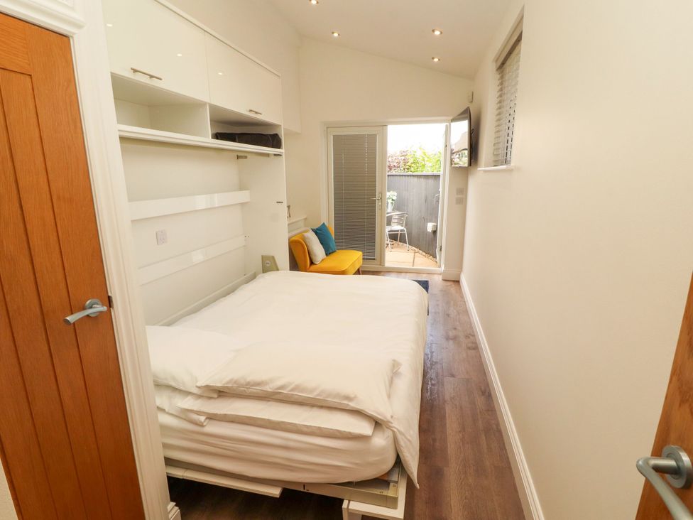 A bedroom with a bed and couch at Flat 1 in Carnforth