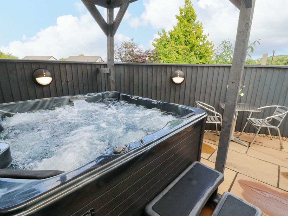 A hot tub with a step and a table with chairs at Flat 1 in Carnforth