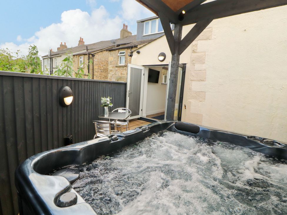 An outdoor hot tub with seating at Flat 1 in Carnforth