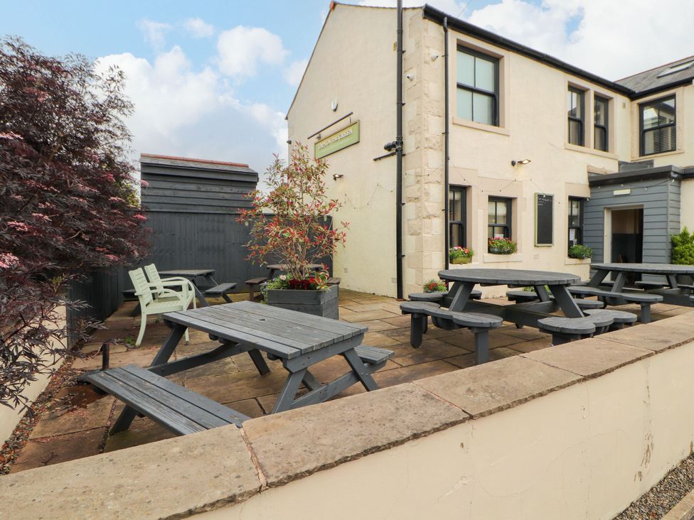 An outdoor seating area with tables and chairs at Flat 1 in Carnforth