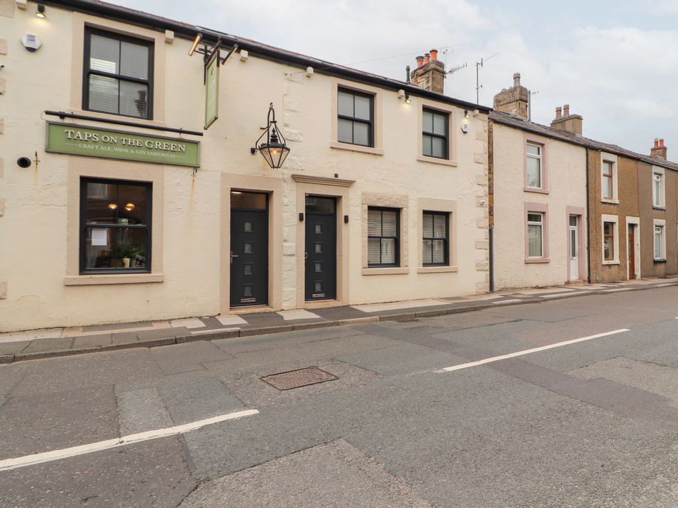 A building exterior with windows and doors at Taps on the Green in Carnforth