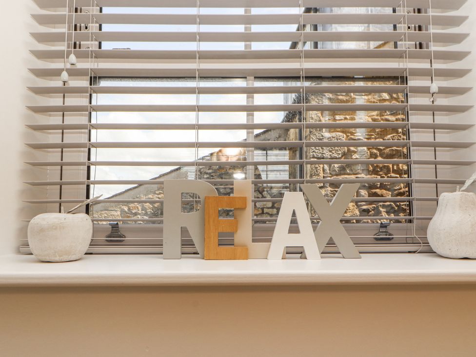 A window with decorative letters on the sill at Flat 2 in Carnforth