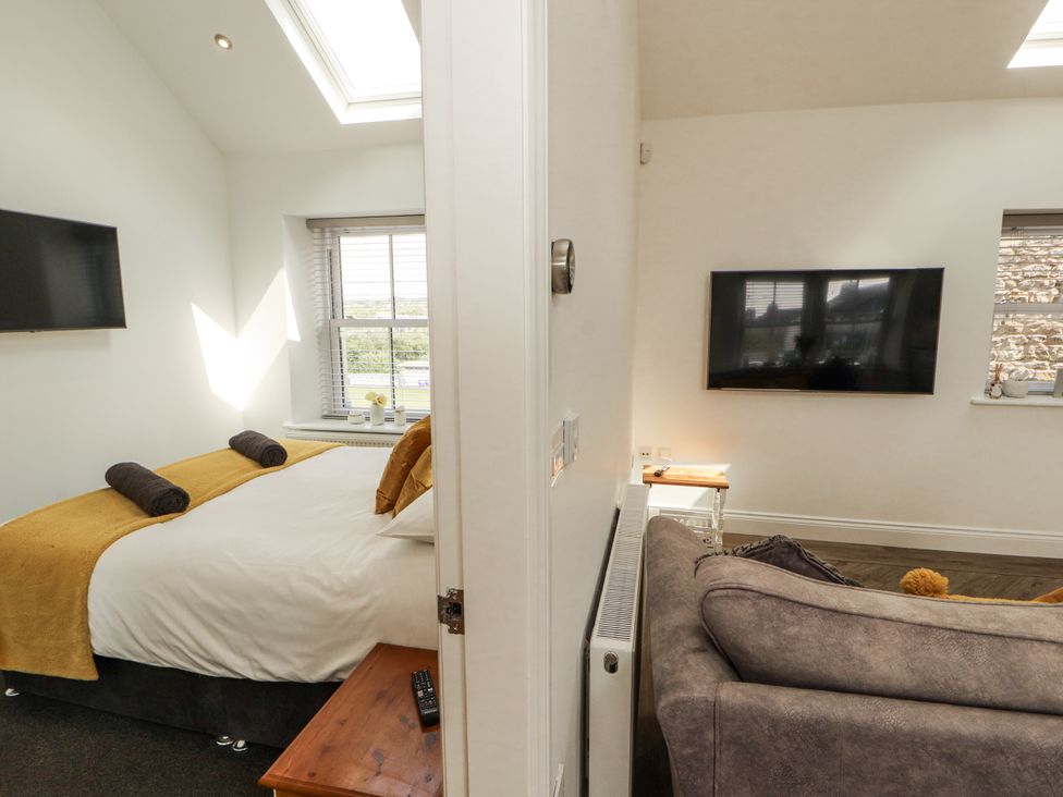 A bedroom with a bed and a television at Flat 2 in Carnforth