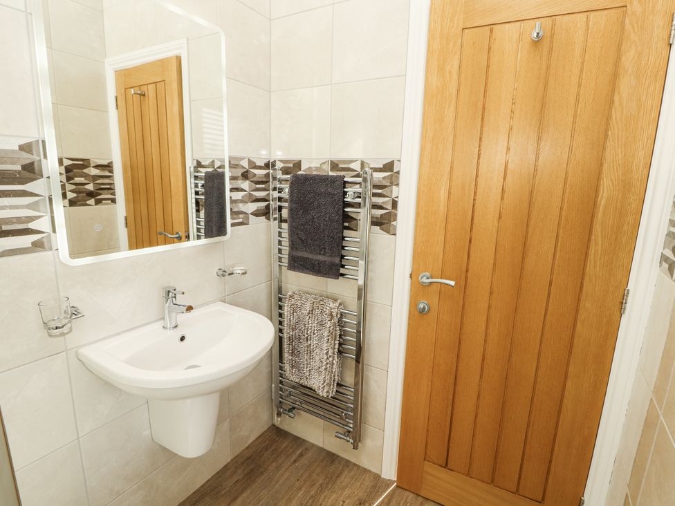 A bathroom with a washbasin and towel rail at Flat 2 Carnforth