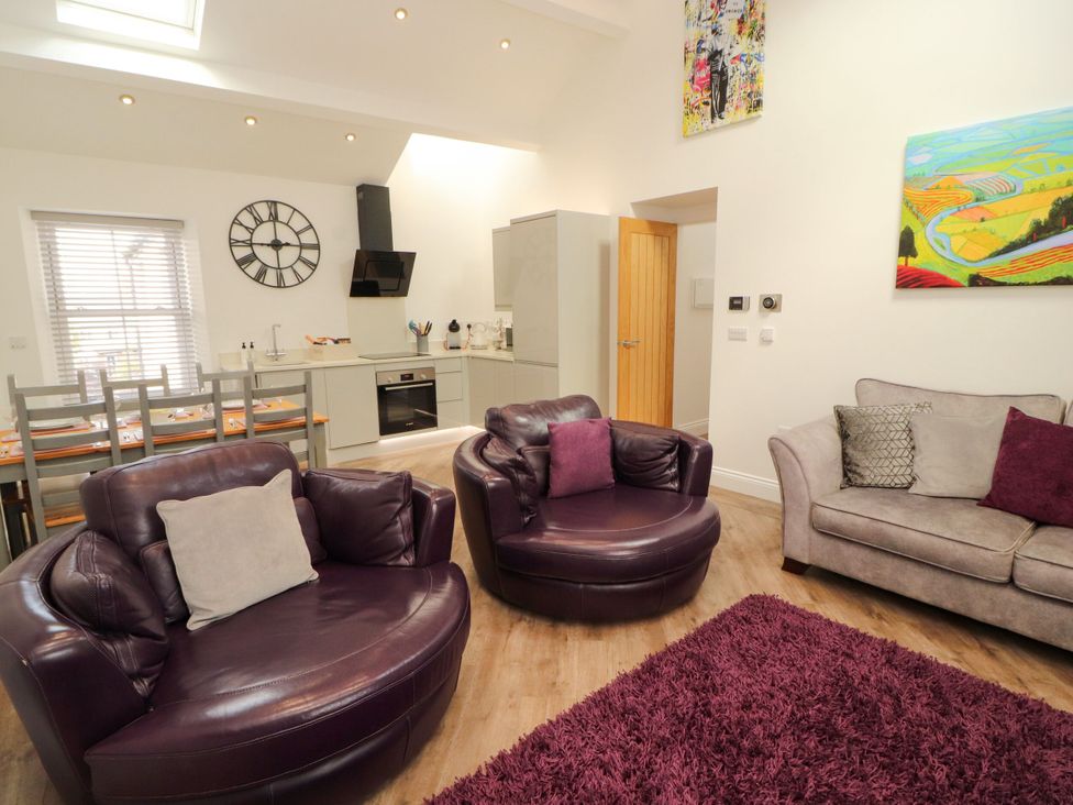 A living room with seating and a dining area at Flat 3 in Carnforth
