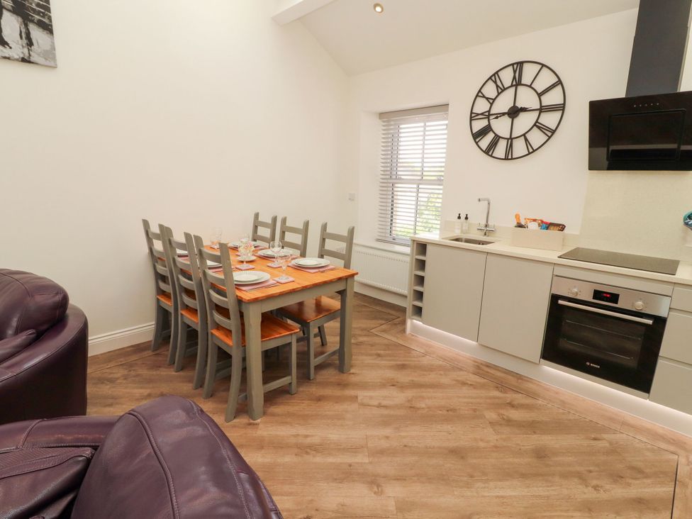 A kitchen with a dining table and chairs at Flat 3 in Carnforth