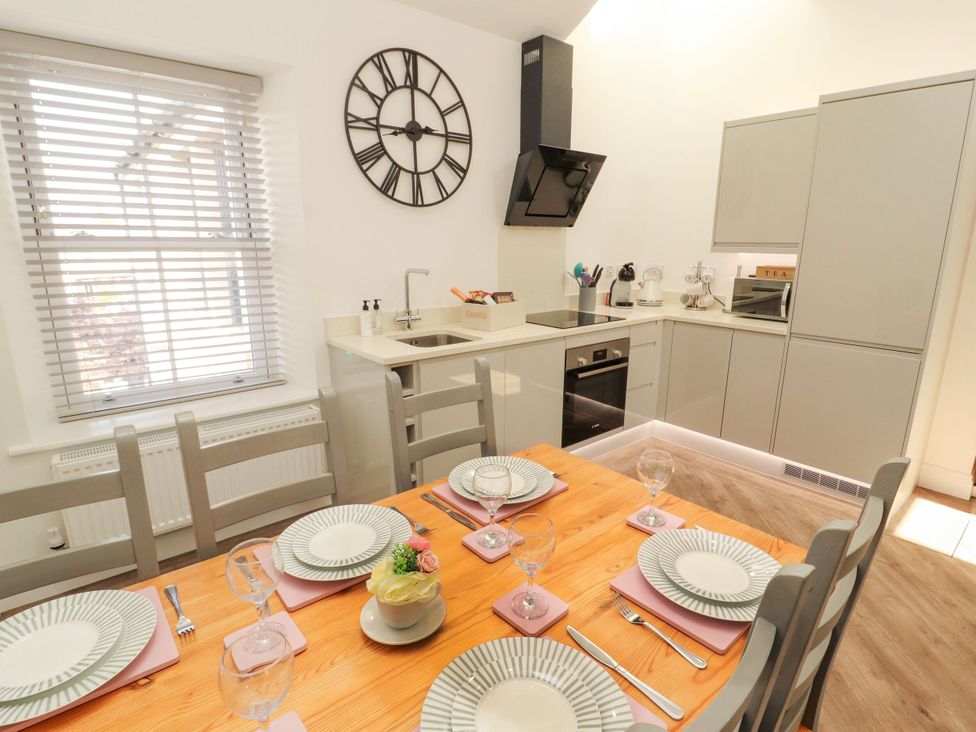 A kitchen with a table set for dinner at Flat 3 in Carnforth
