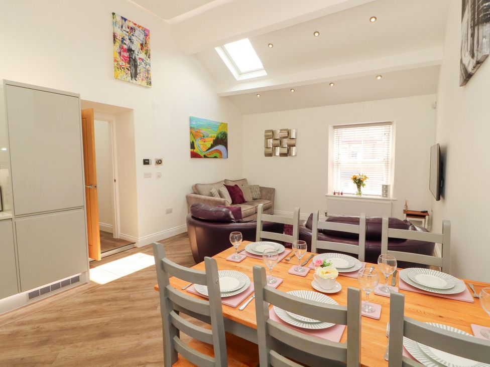 A dining room with a table set for dinner at Flat 3 in Carnforth