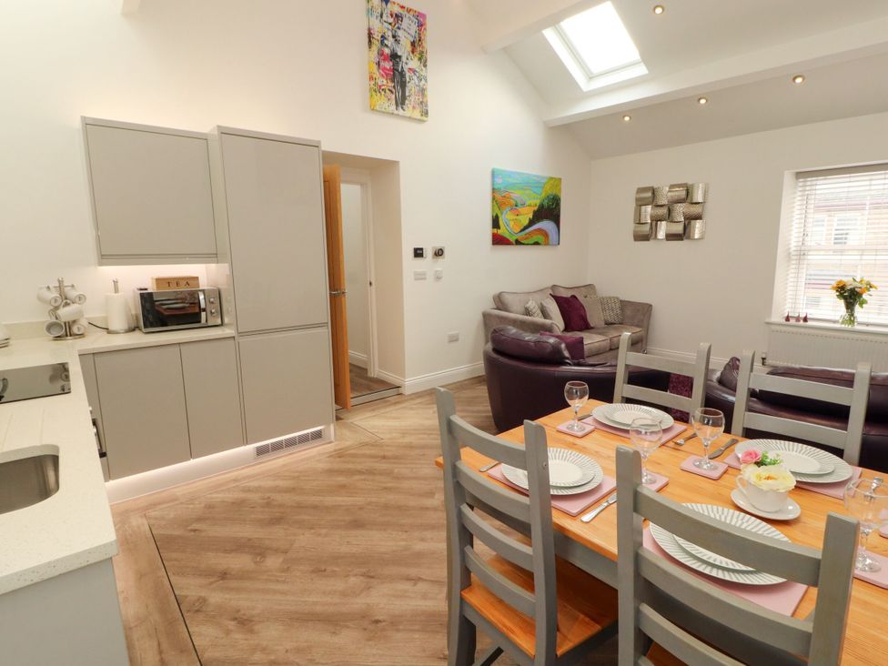 A dining room with a table and chairs in Flat 3, Carnforth