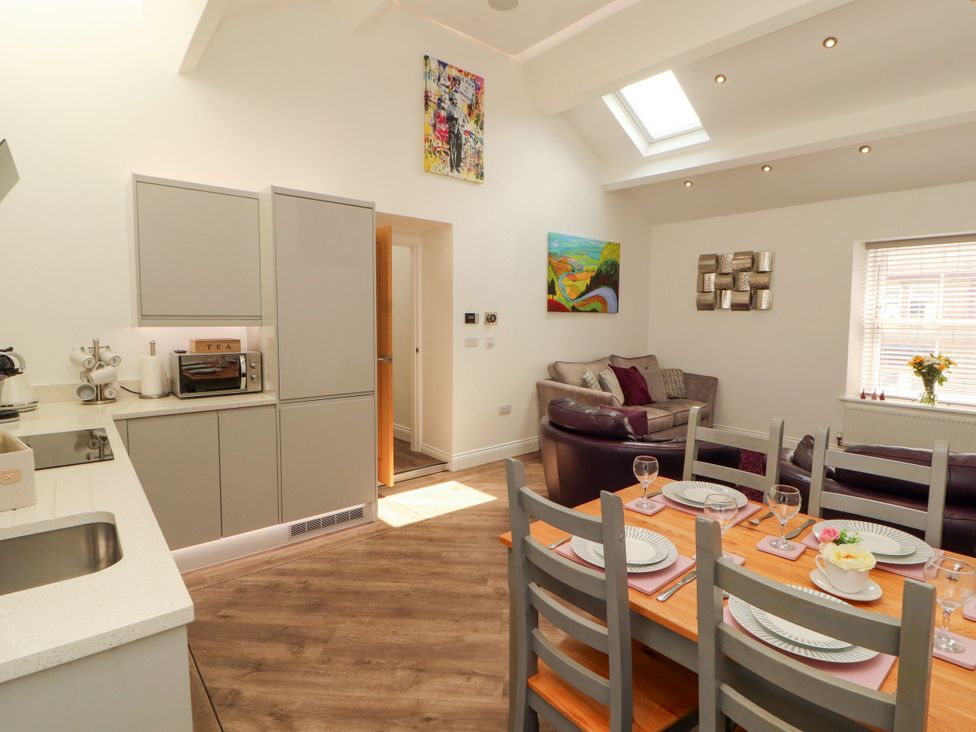 A dining room with a table and chairs at Flat 3 in Carnforth