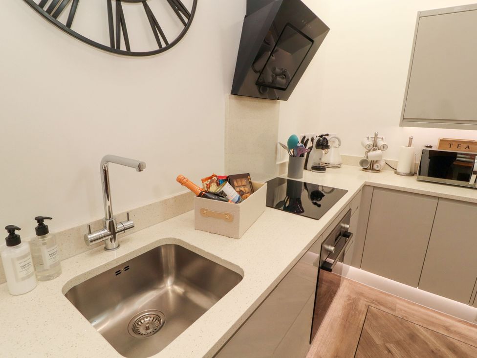 A kitchen with a sink and stove at Flat 3 in Carnforth