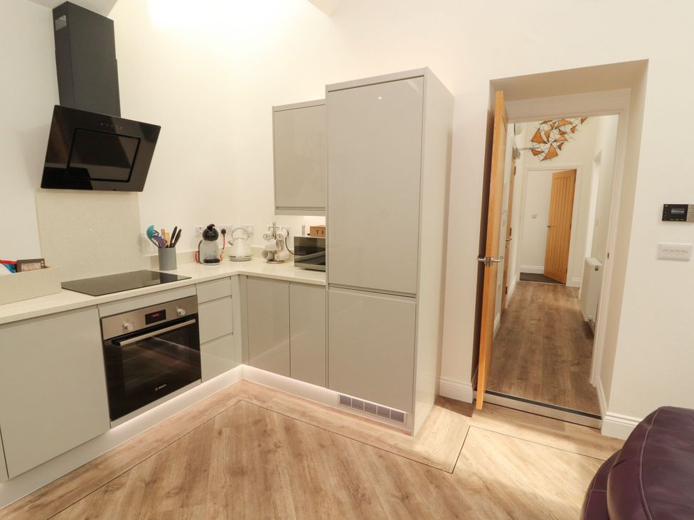 A kitchen with appliances and cabinets at Flat 3 in Carnforth