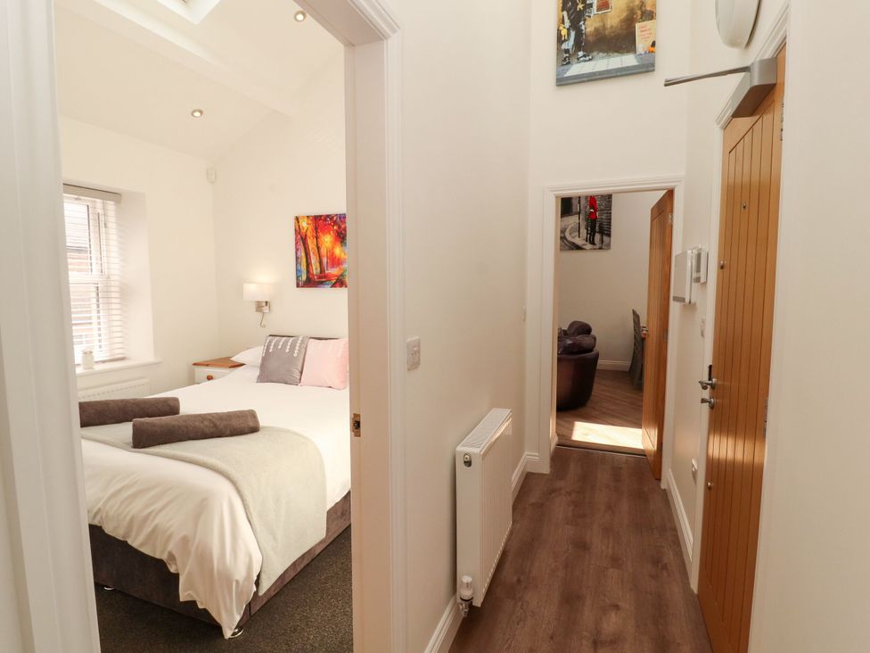 A bedroom with a bed and a window at Flat 3 in Carnforth