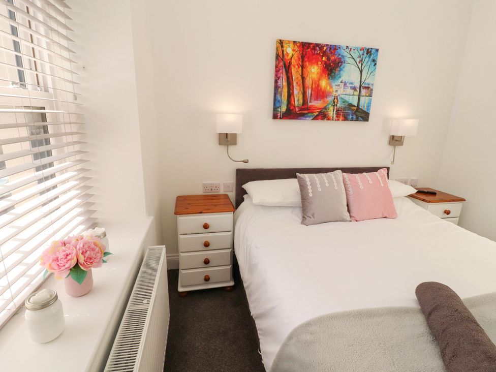 A bedroom with a bed and side tables at Flat 3 in Carnforth
