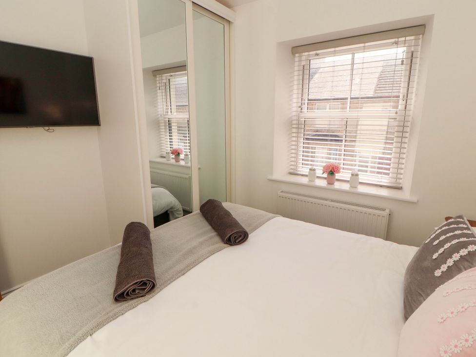 A bedroom with a bed and television at Flat 3 in Carnforth