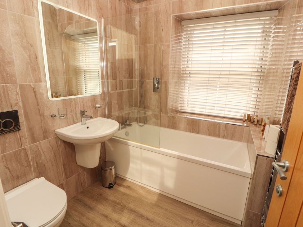 A bathroom with a sink and bathtub at Flat 3 in Carnforth